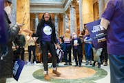 Minister JaNaé Bates led chants Tuesday at the State Capitol with supporters of legislation that would restore felons’ right to vote upon release.
