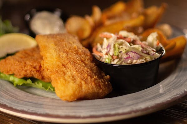 Get hand-breaded cod dinner with slaw and scoop fries at Yankee Tavern in Eagan.