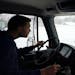 Jesse Rix, a public service worker with the St. Louis Park streets department, uses a snowplow to clear local roadways as snow continued to fall Thurs
