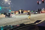 A photo shows someone getting pulled on skis through an intersection in Shakopee.