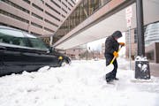 Luis Lara cleared snow off of sidewalks Wednesday in downtown Minneapolis.