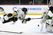 Andover forward Isa Goettl leaped into her shot after she was tripped up while challenging Edina goaltender Uma Corniea.