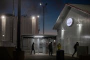 Young workers exit JBS pork plant after an overnight cleaning shift in Worthington, Minn., on Oct. 18, 2022. Their employer, a sanitation company, was