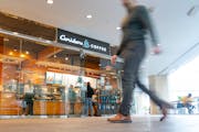 People walk past Caribou Coffee Tuesday, Feb. 28, 2023 inside the skyway in the U.S. Bank building in downtown Minneapolis.