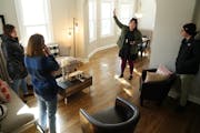 Real estate agent Lydia Kauppi and her showing agent Laura Brenden talked with clients Carrin Baumgartner and Martin McNulty as they toured a home.
