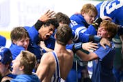 Minnetonka players, including forward Javon Moore (22), left of center, celebrated their 2-1 overtime victory against Chanhassen.