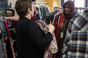 Vice Principal Lisa Purcell shows a blouse option to Rabia Ibrahim, 17, a junior, at the free thrift store at Roosevelt High School in Minneapolis.