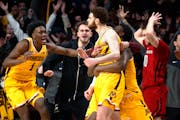 The Gophers celebrated a game-winning three-pointer by Jamison Battle, center, against Rutgers on Thursday.