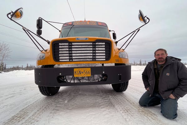 Stretch Blackard, owner of Tok Transportation, poses with an electric school bus on Feb. 2, 2023, in Tok, Alaska. “It is a problem to have batteries