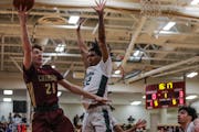 Braedy Laliberte of Maple Grove went to the basket against JJ Ware of Park Center on Friday, when Maple Grove won 67-64 and shook up the Metro Top 10.