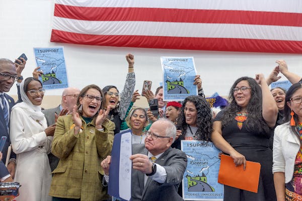 Supporters, politicians and bill authors react after Minnesota Governor Tim Walz signed the driver’s licenses for all bill at the Cedar Street Armor