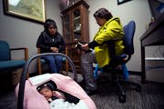 Sara Hernandez, right, read a Bible verse with Geholmin Yomilner Coronado Morales and her 1-month-old baby at Helping Hand Pregnancy Center in Worthin