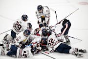 Teammates piled on in celebration after Avery Anderson scored in overtime for Orono.