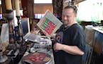 Dan Van Eijl switched out a record inside his coffee shop, the Jazz Shepherd, on March 8 in Elgin, Minn. Van Eijl uses his massive collection of jazz 