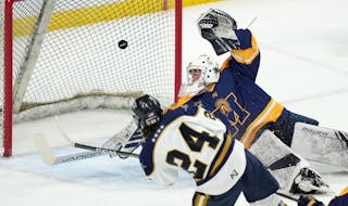 Hermantown forward Dallas Vieau (24) scored past Mahtomedi goaltender Charles Brandt (30) in the first period of the Class 1A state semifinal on Frida