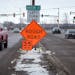 Vehicles passed Davern Street on Shepard Road in St. Paul on Friday. Crews gave up filling potholes and chose instead to cut speed limits from 50 to 3