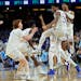 Kansas guard Ochai Agbaji celebrates with teammates after their win against North Carolina in a college basketball game in the finals of the Men’s F