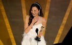 Michelle Yeoh accepts the award for best performance by an actress in a leading role for “Everything Everywhere All at Once” at the 2023 Oscars.