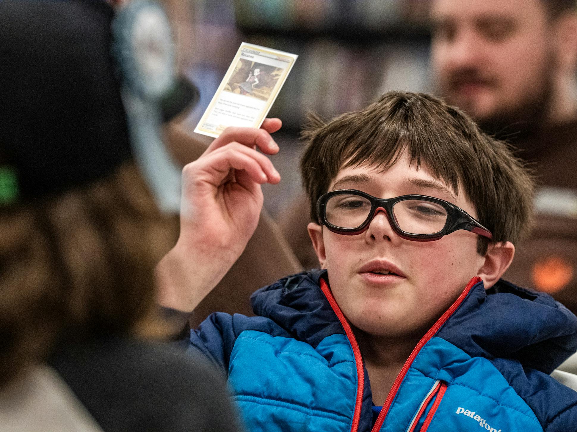 At a game store in South St. Paul, Harrison showed one of his cards at a Pokémon gathering. His experience demonstrates the bind families are in when they seek mental health services.