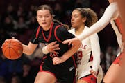 Lakeville North guard Gabby Betton wrapped an arm around Stillwater forward Elise Dieterle on Wednesday. 