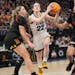 Iowa star Caitlin Clark drove to the basket, finding a seam between  Maryland’s Faith Masonius, left, and Lavender Briggs in the semifinals of the B