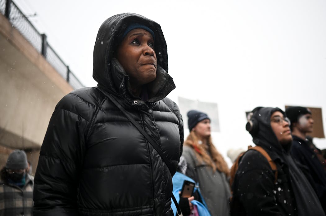 Minneapolis City Council President Andrea Jenkins listened to speakers during a transgender rights rally March 9 at the Lake Street/Midtown Transit Station in Minneapolis.