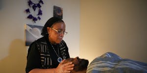 Kinshasha Kambui massages the face of Duane Whitaker at Wellness Paradigm in Minneapolis on March 3. Wellness Paradigm is a Black-owned space focused 