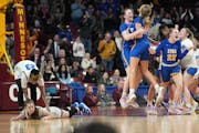 Moods differed strongly Saturday, when  St. Michael-Albertville players celebrated their 71-70 victory while Hopkins’ Kelly Boyle showed another emo