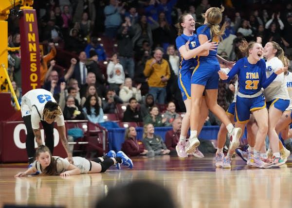 Moods differed strongly Saturday, when  St. Michael-Albertville players celebrated their 71-70 victory while Hopkins’ Kelly Boyle showed another emo