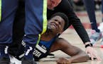 Anthony Edwards of the Wolves grimaced on the floor after suffering a non-contact injury in Friday’s game in Chicago.