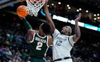 Tyson Walker scored 23 points and punctuated Michigan State’s 69-60 victory over Marquette with a steal and his first ever collegiate dunk to lift t