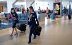 American Airlines flight attendants walk along the concourse at DFW International Airport. (Smiley N. Pool/Dallas Morning News/TNS)