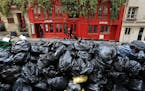 Uncollected garbage is piled up on a street in Paris, Monday, March 20, 2023.