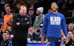 New York Knicks head coach Tom Thibodeau, left, puts guard Derrick Rose in after the fans called for him during the second half of an NBA basketball g