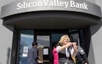 A woman who was part of a line entering the Silicon Valley Bank’s headquarters paused for a selfie in Santa Clara, Calif., on Monday, March 13, 2023