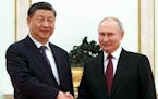 Chinese President Xi Jinping and Russian President Vladimir Putin pose for a photo during their meeting at the Kremlin in Moscow, Russia, Monday, Marc