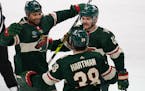 Wild players Ryan Reaves, Sam Steel (13) and Ryan Hartman celebrated after Reaves scored in Sunday’s victory over the Capitals.