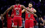 Chicago Bulls’ Zach LaVine (8) and Derrick Jones Jr. (5) celebrate during double overtime.
