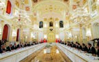 Delegations from Russia, left, and China, right, talk at the Grand Kremlin Palace, in Moscow on Tuesday.
