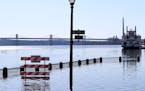 A walkway is under water along the St. Croix River during spring flooding Tuesday March 31, 2020, in downtown Stillwater.
