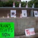 Candles and signs with photos and names of transgender people who have been killed due to suicide or violence against the transgender community were o
