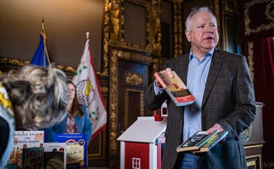 Gov. Tim Walz discussed some of the books banned elsewhere that are going into the Little Free Library outside his office, on Wednesday at the State C
