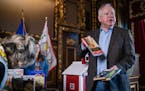 Gov. Tim Walz discussed some of the books banned elsewhere that are going into the Little Free Library outside his office, on Wednesday at the State C