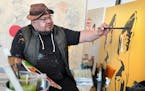 Artist Frank Buffalo Hyde paints in his Northfield garage-turned-studio, preparing for an upcoming solo exhibition titled “Native Americana.”