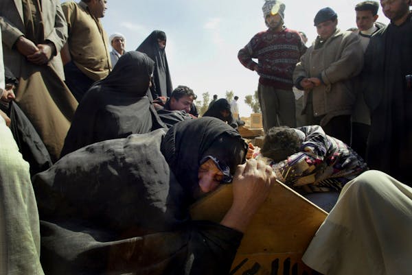 Relatives mourn at a funeral on the outskirts of Baghdad, Iraq, on March 29, 2003. Iraq lost nearly half a million civilians in the war and years of o