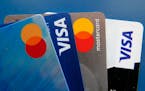 File - Credit cards as seen July 1, 2021, in Orlando, Fla. A low credit score can hurt your ability to take out a loan, secure a good interest rate, o