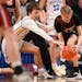 Carter Zimmerman of Mankato Loyola and Jaxon Strinmoen of Spring Grove battled for a loose ball in the second half Wednesday during a Class 1A boys ba