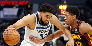 Timberwolves center Karl-Anthony Towns, playing in his first game since November, works past Hawks forward De’Andre Hunter in the first quarter Wedn