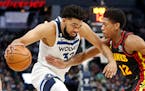 Timberwolves center Karl-Anthony Towns, playing in his first game since November, works past Hawks forward De’Andre Hunter in the first quarter Wedn