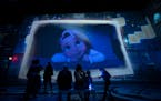 Guests watch animation projected  on all walls and the floor during the Lighthouse Immersive Studio’s Immersive Disney Animation in Minneapolis, Min